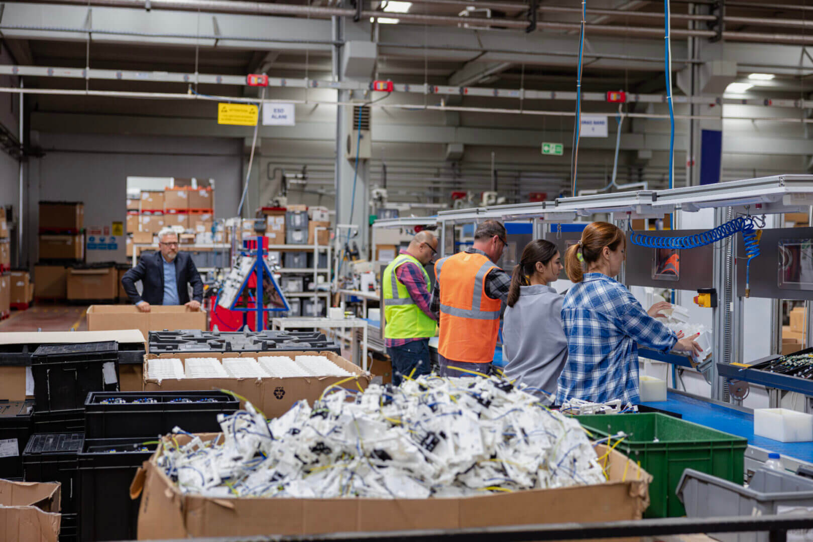 Workers sorting materials in a recycling facility.